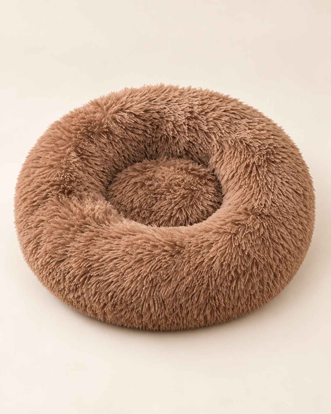 Coffee-brown round plush pet bed with a shaggy raised rim and recessed center on an ivory background.