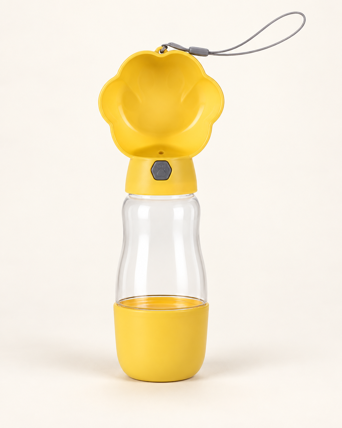 Yellow portable dog water bottle with paw-shaped drinking tray, clear reservoir, food cup and gray wrist strap.