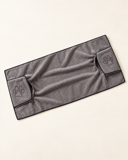 Gray rectangular microfiber dog drying towel with dark edging and two paw-embroidered hand pockets.